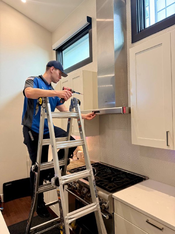 Quick Tweak technician installing a kitchen vent hood