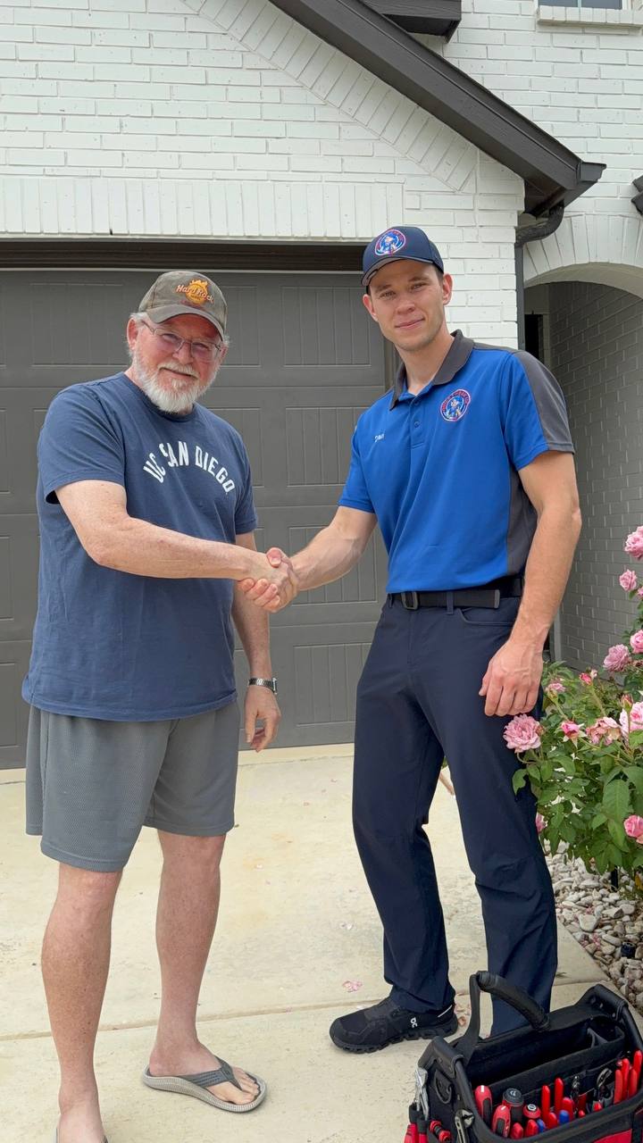 A Quick Tweak technician shaking hands with a satisfied customer at their San Antonio home